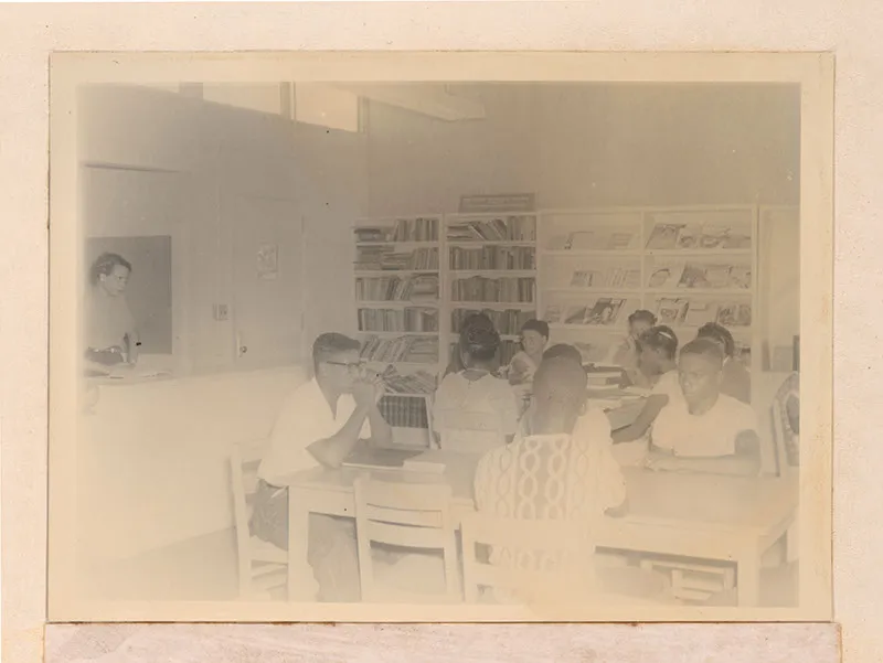 African American students gathered around books in a 1951 Georgia library